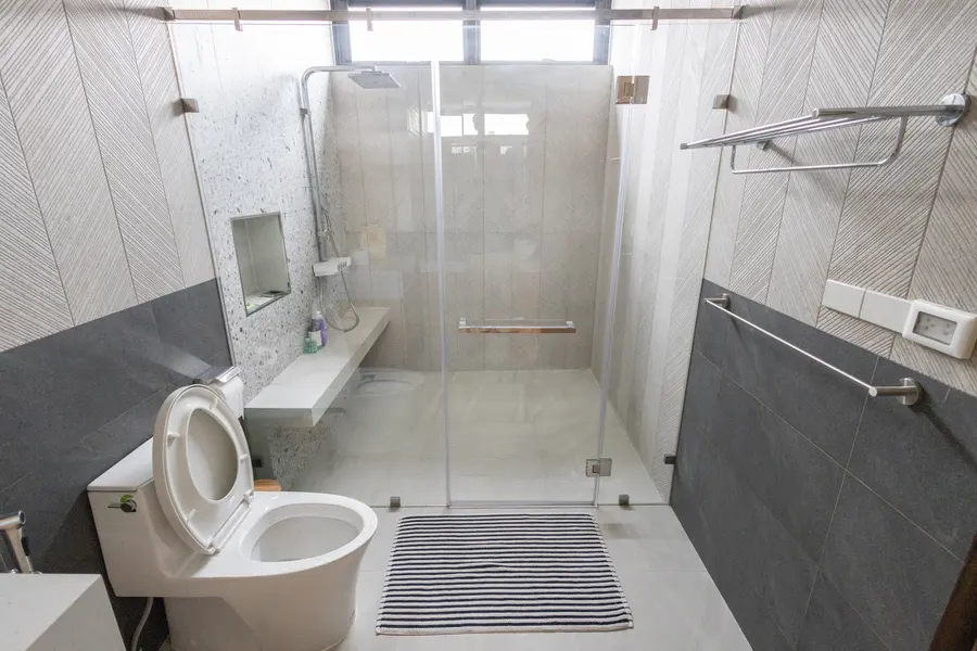 Bathroom with round mirror and walk-in shower