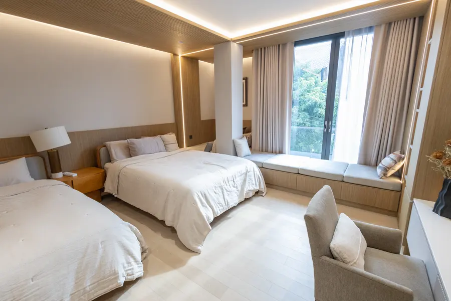 Bedroom with window seating and warm lighting