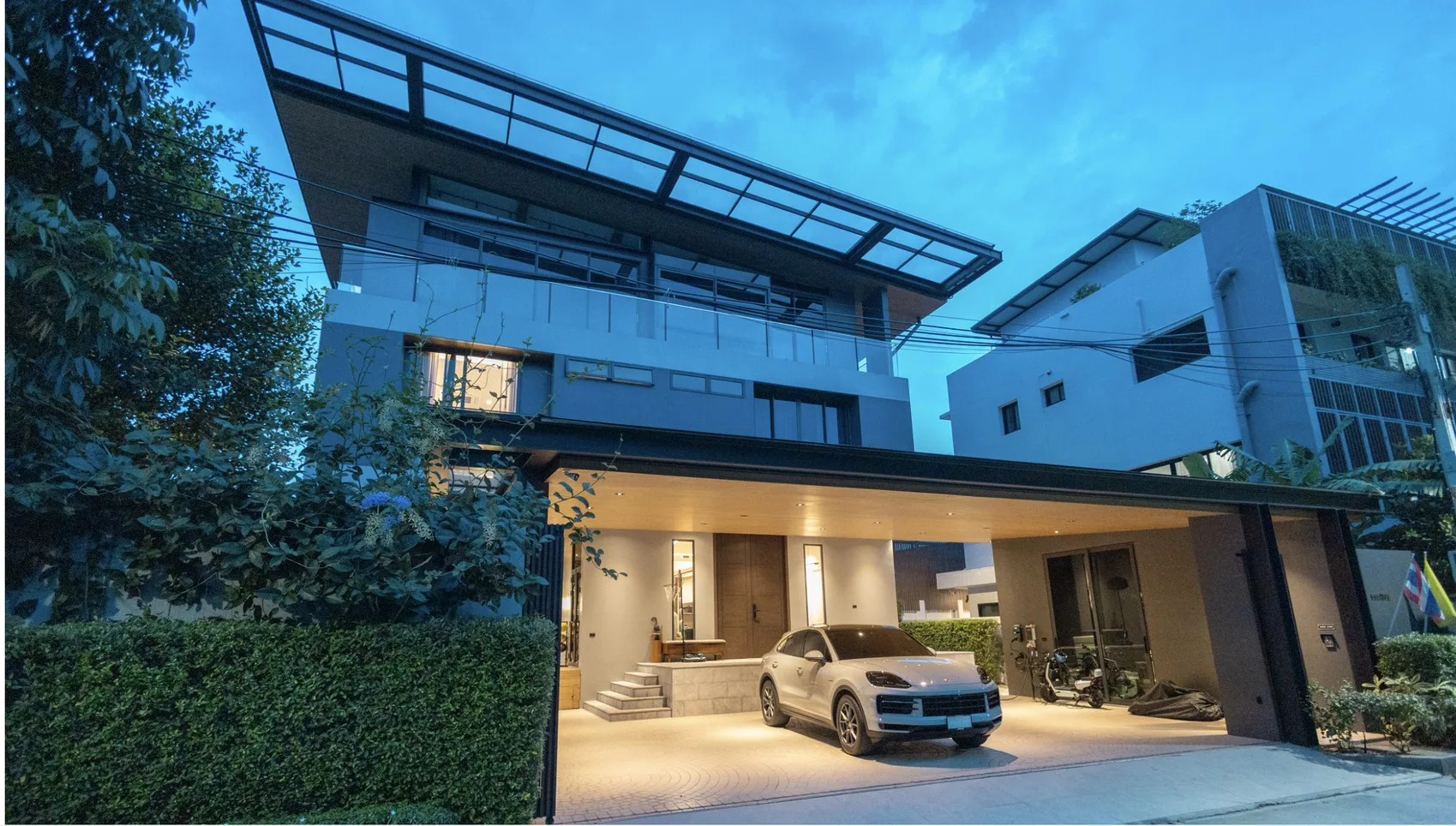 Exterior of the Kesinee Ville residence at dusk